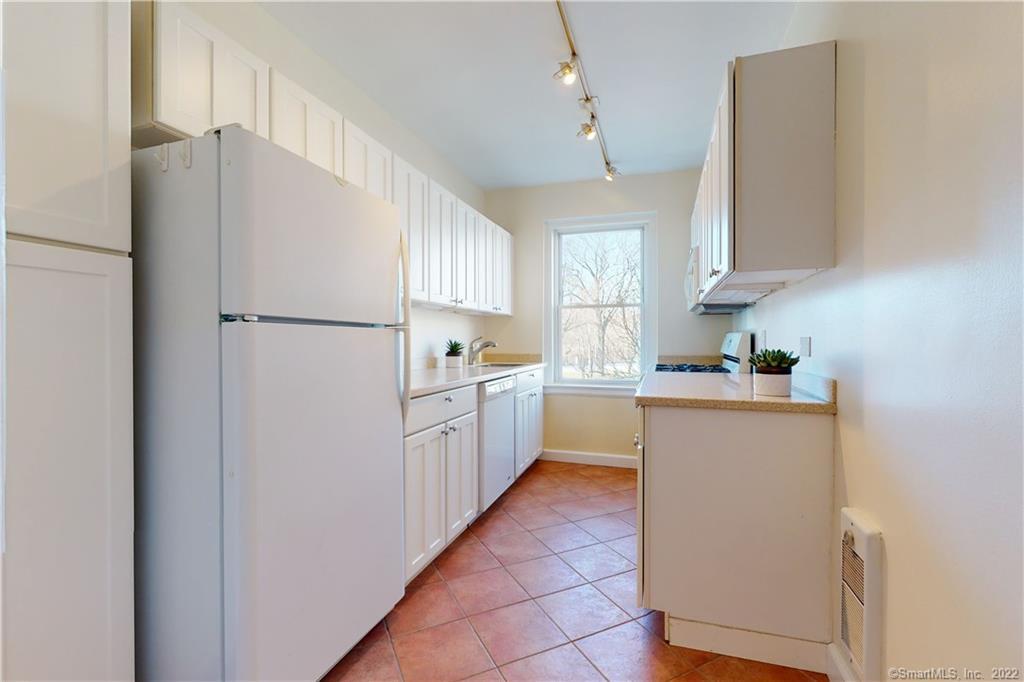 a kitchen with cabinets and white appliances