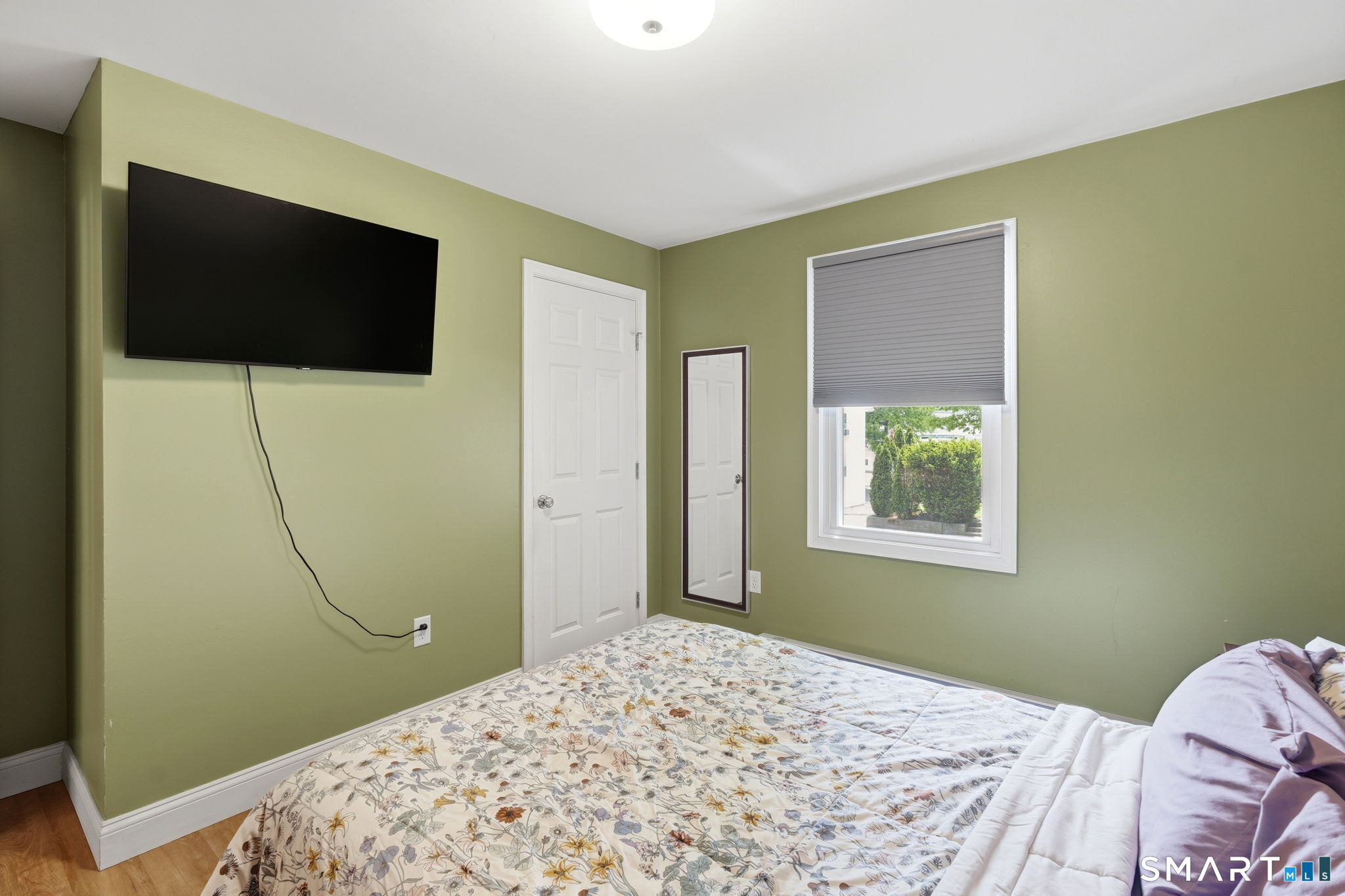 71 Smith Street Putnam, CT 06260 - Photo 4 of 25 a bedroom with bed and a flat screen tv