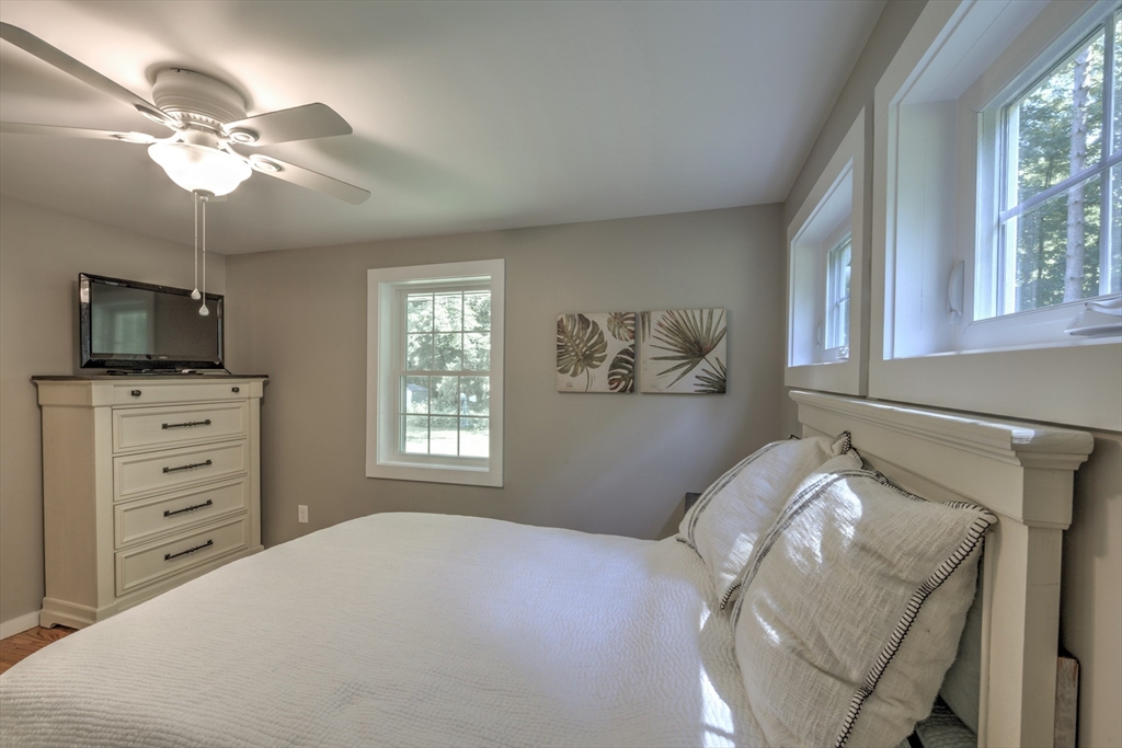 428 Bridge Road Northampton, MA 01062 - Photo 19 of 42 a bedroom with a bed and a flat screen tv