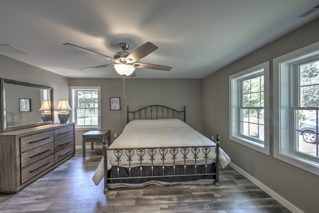 428 Bridge Road Northampton, MA 01062 - Photo 29 of 42 a bedroom with a large bed and a chandelier