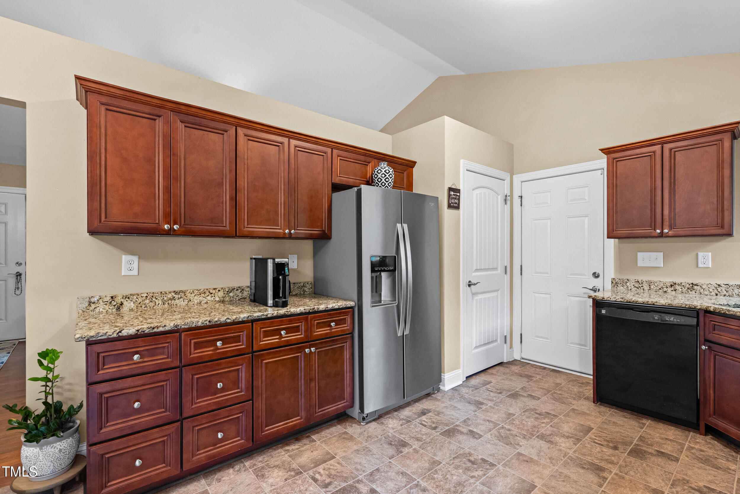 421 Angus Place Stem, NC 27581 - Photo 10 of 22 a kitchen with stainless steel appliances granite countertop a refrigerator and a stove top oven