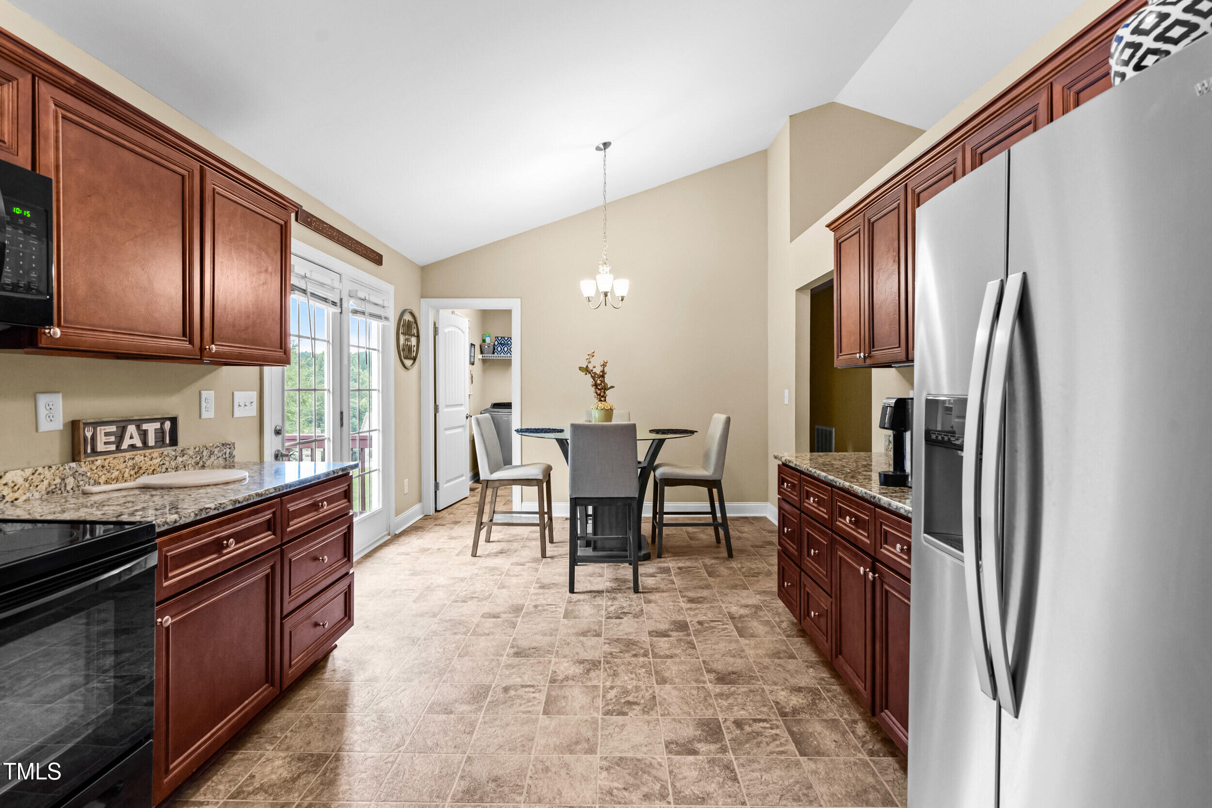 421 Angus Place Stem, NC 27581 - Photo 11 of 22 a kitchen with stainless steel appliances granite countertop a refrigerator and a stove top oven