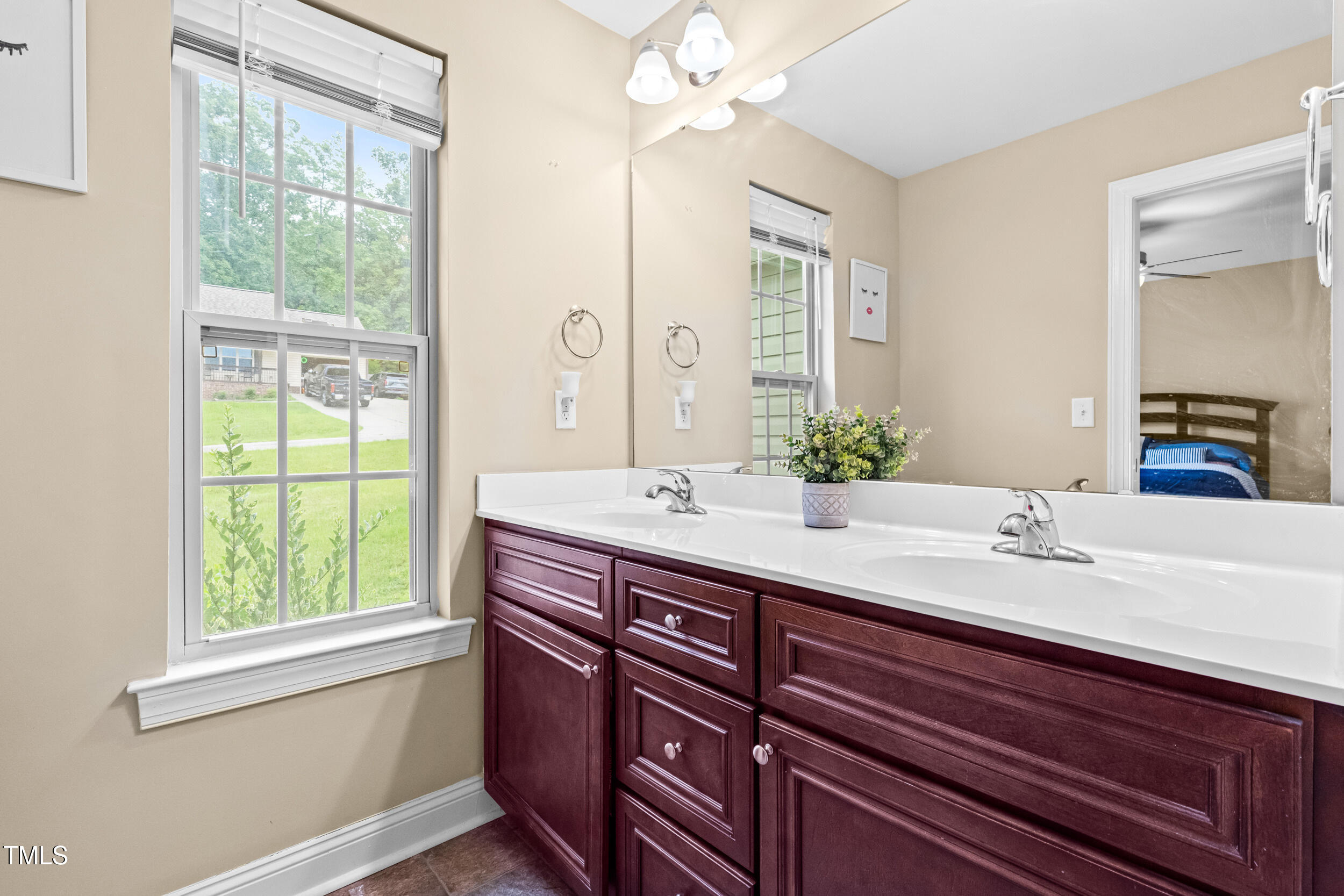 421 Angus Place Stem, NC 27581 - Photo 13 of 22 a bathroom with a double vanity sink and a mirror