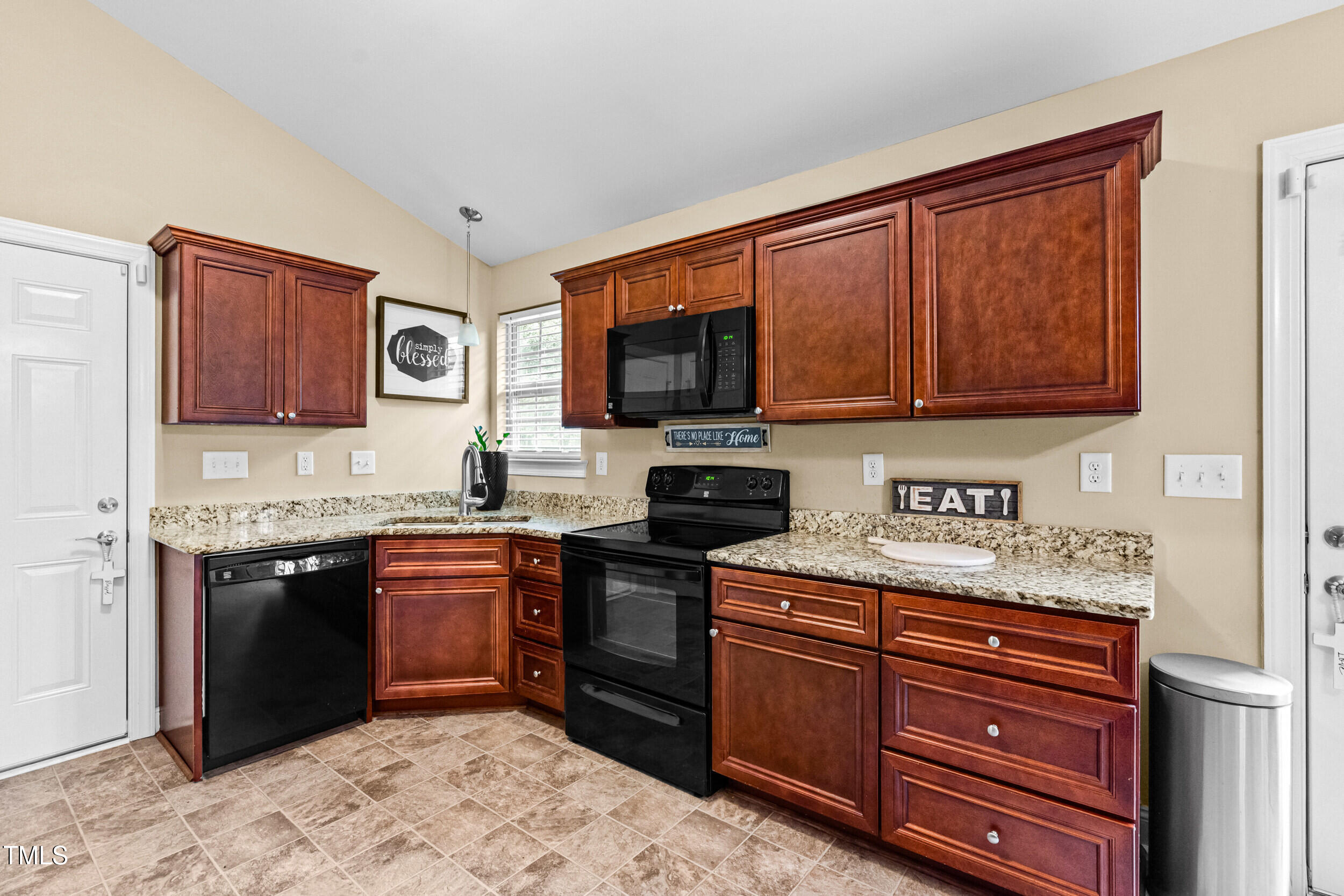 421 Angus Place Stem, NC 27581 - Photo 3 of 22 a kitchen with stainless steel appliances granite countertop wooden cabinets a stove top oven a sink and dishwasher
