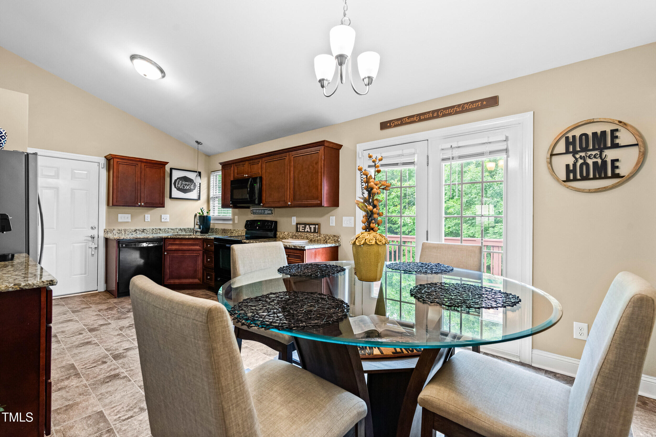 421 Angus Place Stem, NC 27581 - Photo 6 of 22 a kitchen with stainless steel appliances granite countertop a stove a refrigerator a kitchen island a dining table and chairs
