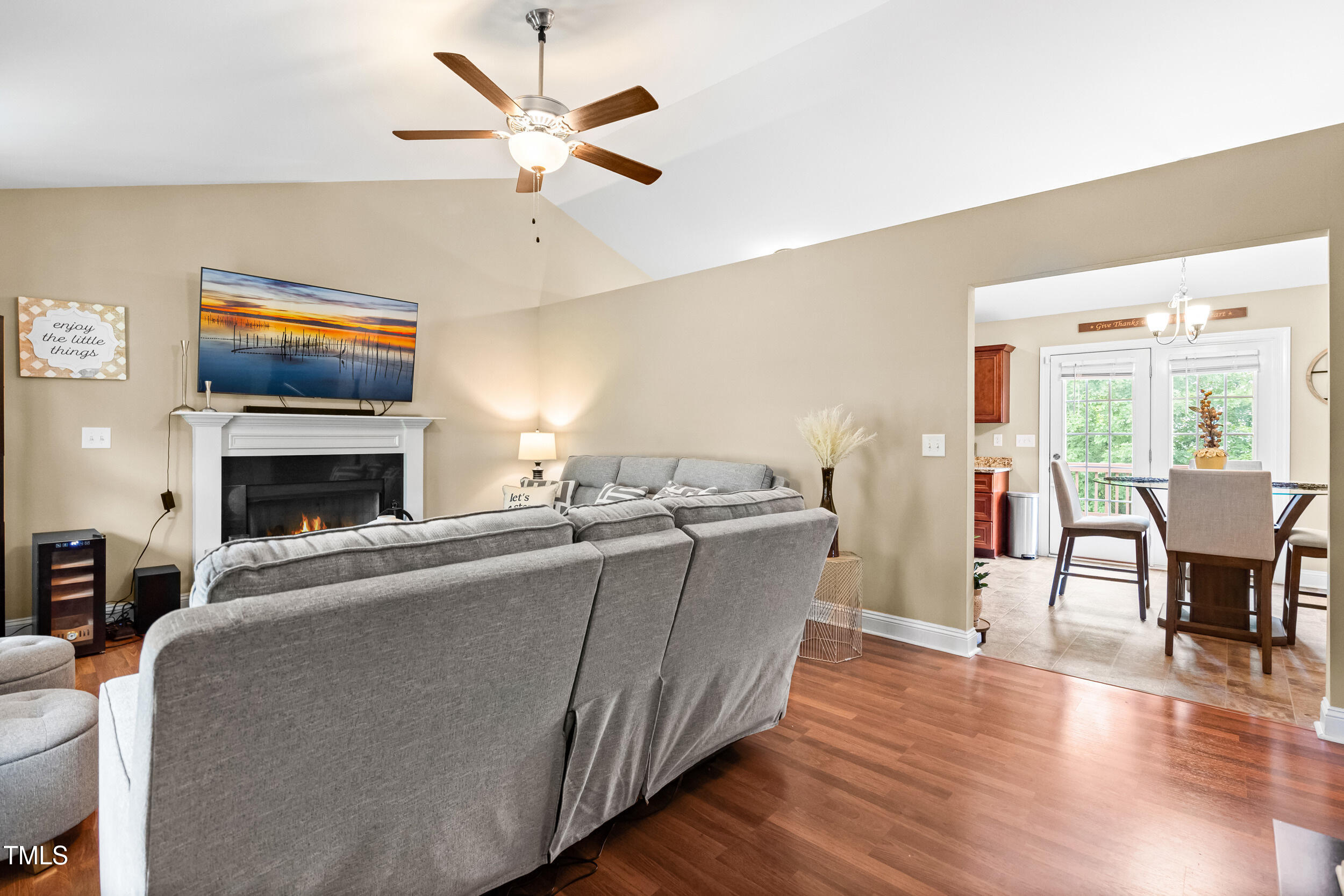 421 Angus Place Stem, NC 27581 - Photo 8 of 22 a living room with furniture a fireplace and a flat screen tv