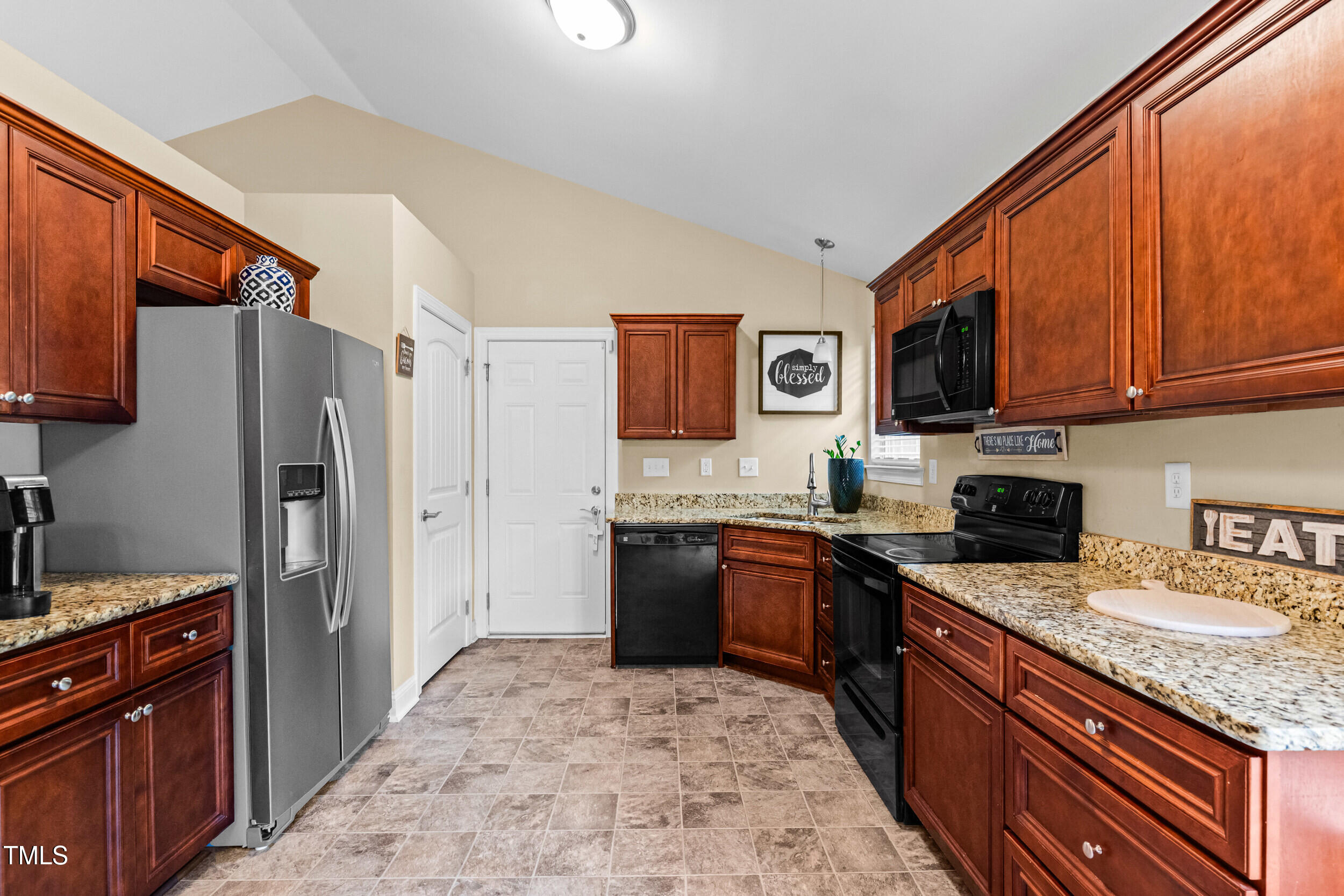 421 Angus Place Stem, NC 27581 - Photo 9 of 22 a kitchen with stainless steel appliances granite countertop a stove refrigerator sink and microwave