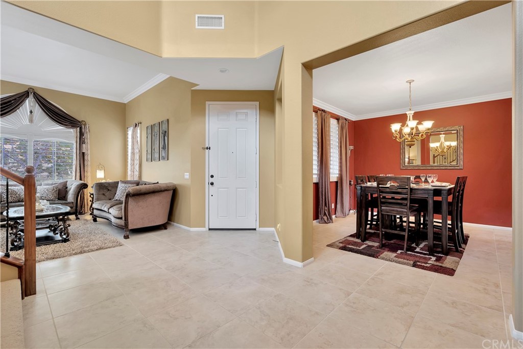 3426 Amethyst Street Corona, CA 92882 - Photo 11 of 72 a view of a dining room with furniture and chandelier