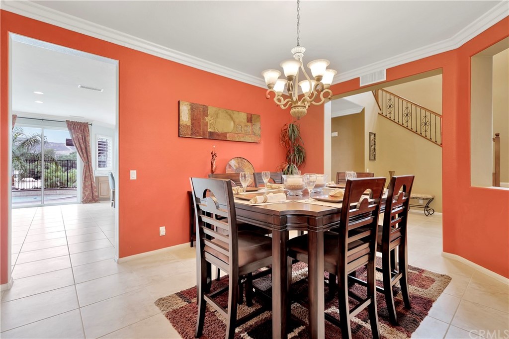 3426 Amethyst Street Corona, CA 92882 - Photo 12 of 72 a view of a dining room with furniture and chandelier