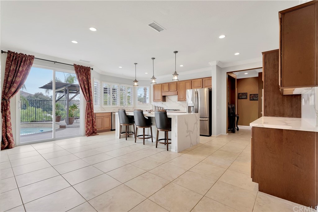 3426 Amethyst Street Corona, CA 92882 - Photo 16 of 72 a large kitchen with a large counter top sink stainless steel appliances and cabinets