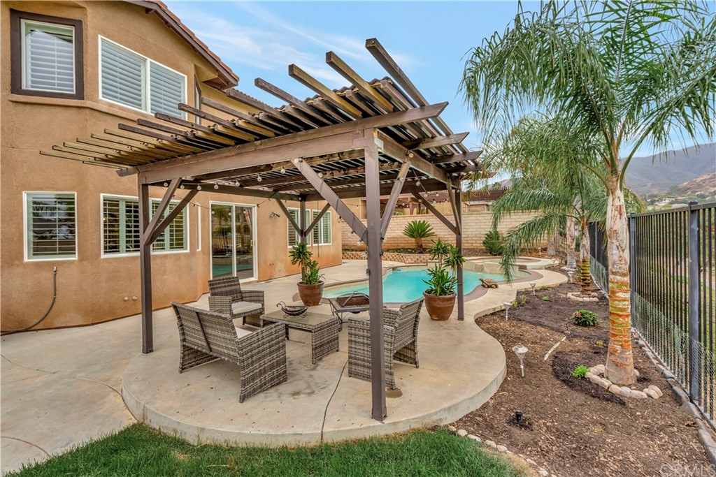 3426 Amethyst Street Corona, CA 92882 - Photo 26 of 72 a view of a patio with table and chairs with wooden floor and fence
