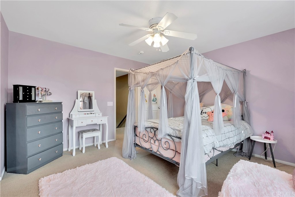 3426 Amethyst Street Corona, CA 92882 - Photo 47 of 72 a bedroom with a bed and a chandelier