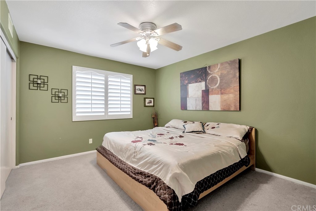 3426 Amethyst Street Corona, CA 92882 - Photo 48 of 72 a bedroom with a bed and a chandelier