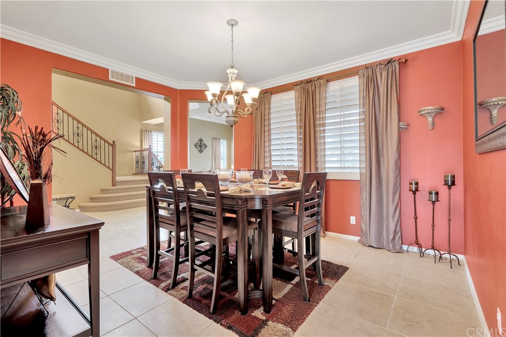 3426 Amethyst Street Corona, CA 92882 - Photo 54 of 72 a view of a dining room with furniture and chandelier