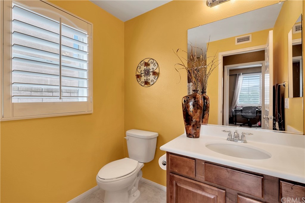 3426 Amethyst Street Corona, CA 92882 - Photo 57 of 72 a bathroom with a toilet sink and mirror