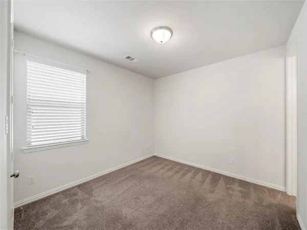 a bathroom with a bathtub shower sink mirror vanity and a toilet