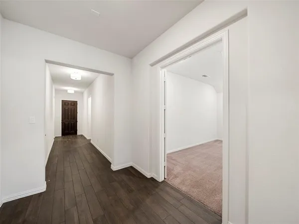 a view of hallway with wooden floor