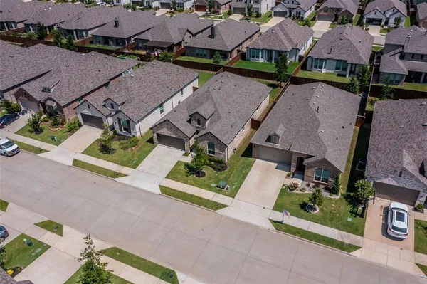 an aerial view of a swimming pool with a yard
