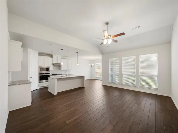 a view of kitchen with sink and wooden floor