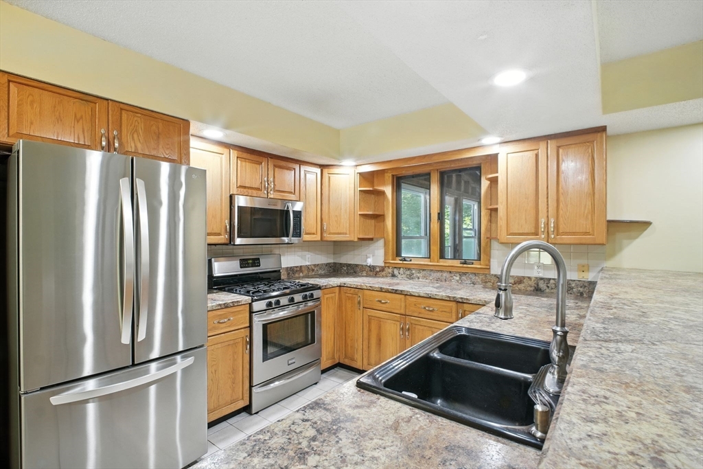 164 Wales Road Monson, MA 01057 - Photo 11 of 41 a kitchen with stainless steel appliances granite countertop a refrigerator stove and sink