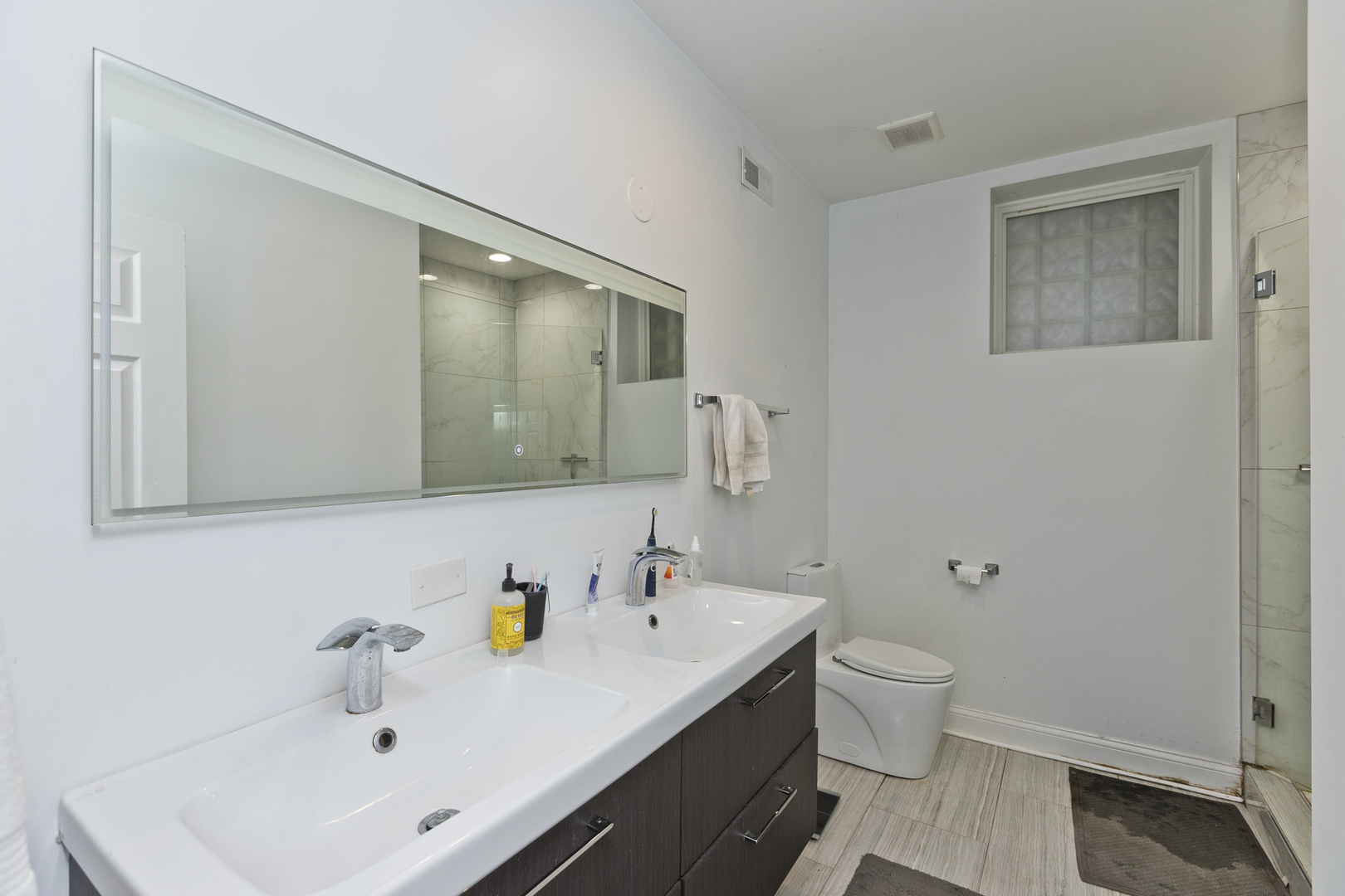 Undisclosed Address Chicago, IL 60614 - Photo 17 of 21 a bathroom with a sink a toilet and shower