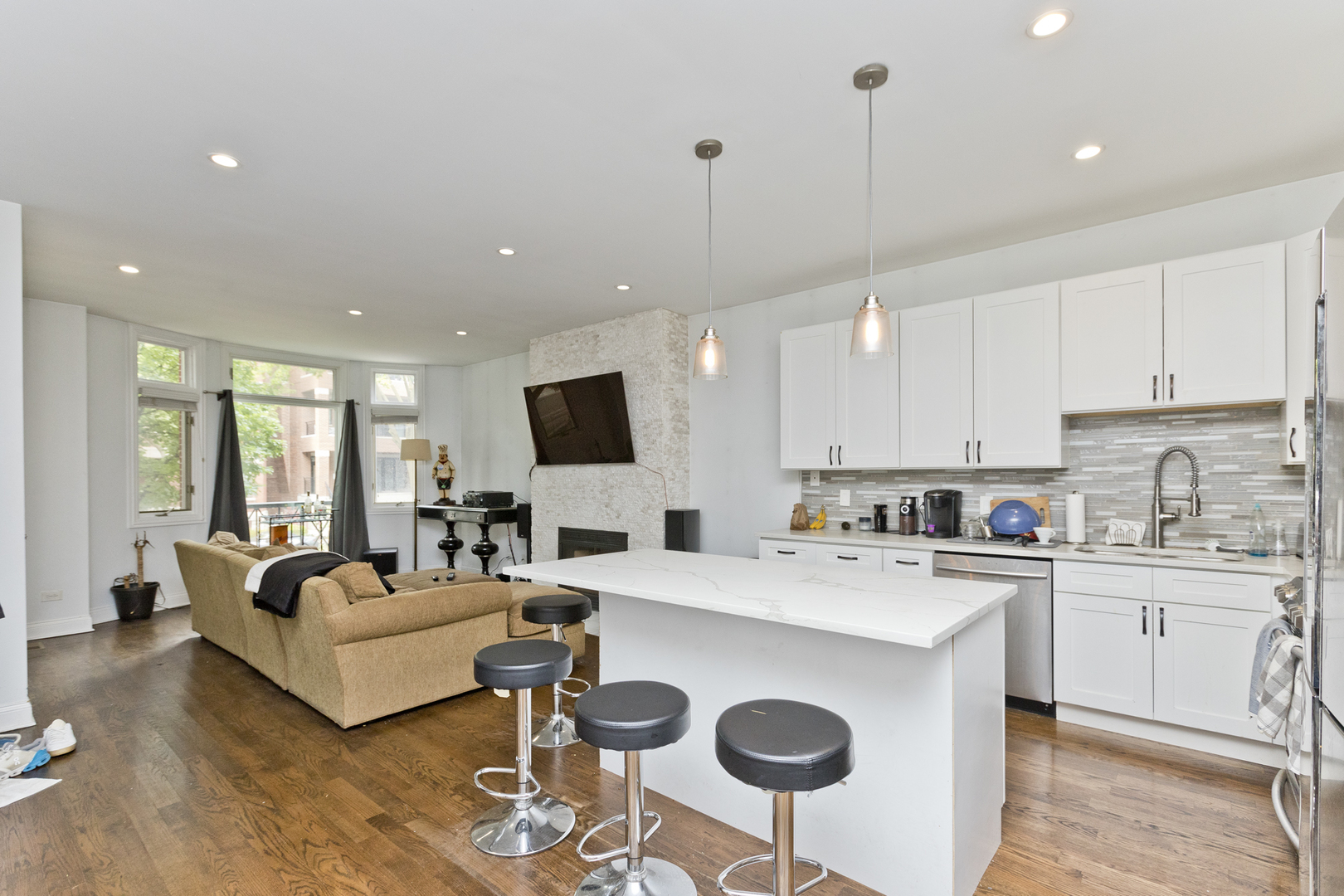Undisclosed Address Chicago, IL 60614 - Photo 2 of 21 a view of kitchen with stainless steel appliances granite countertop sink stove and white cabinets with wooden floor