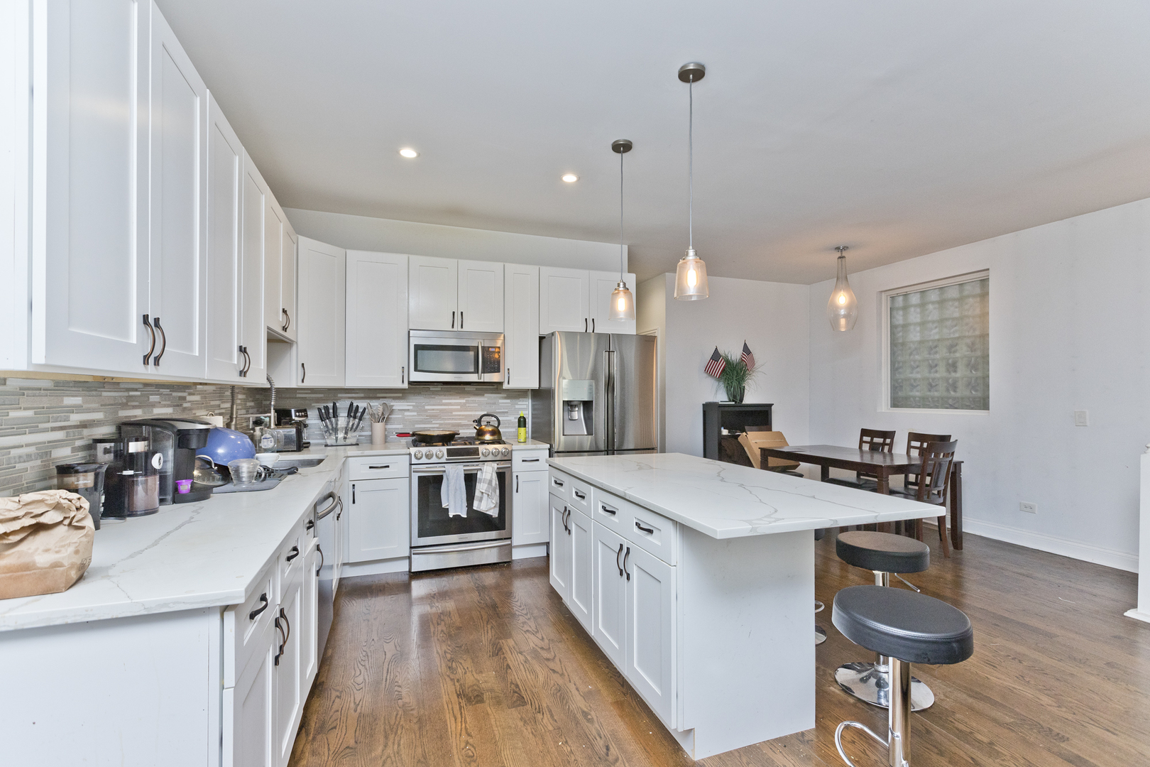 Undisclosed Address Chicago, IL 60614 - Photo 7 of 21 a large kitchen with stainless steel appliances lots of counter space and wooden floor