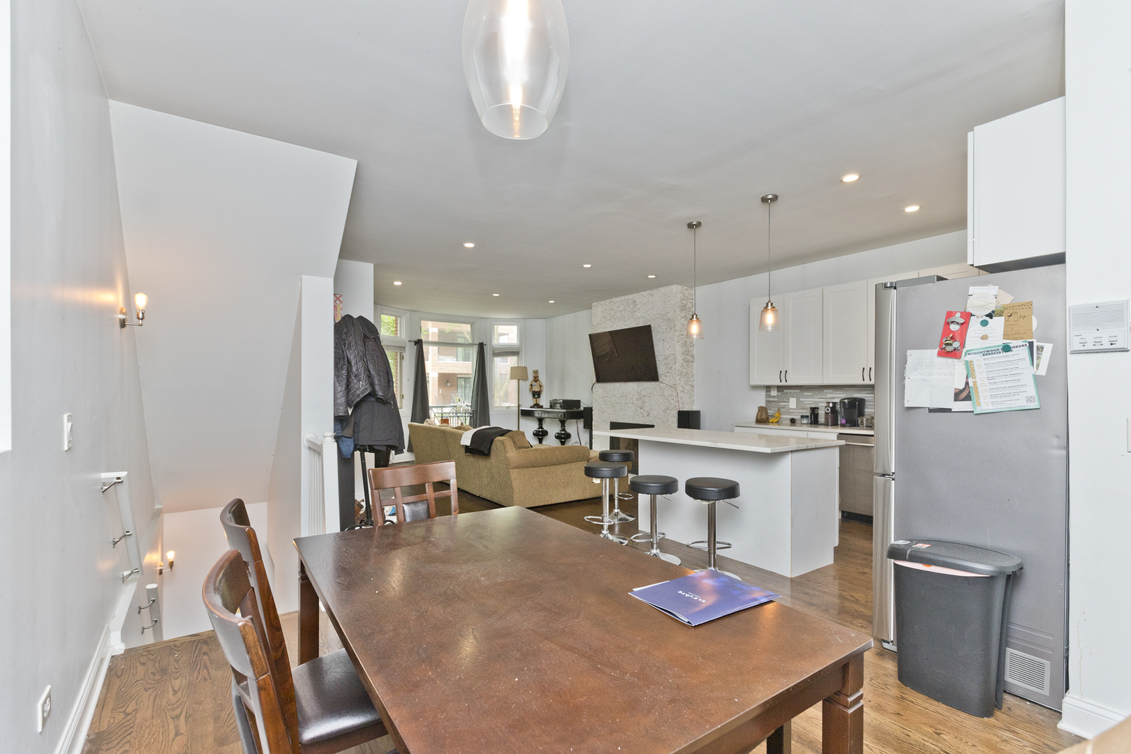 Undisclosed Address Chicago, IL 60614 - Photo 9 of 21 a kitchen with stainless steel appliances granite countertop a dining table chairs stove and white cabinets