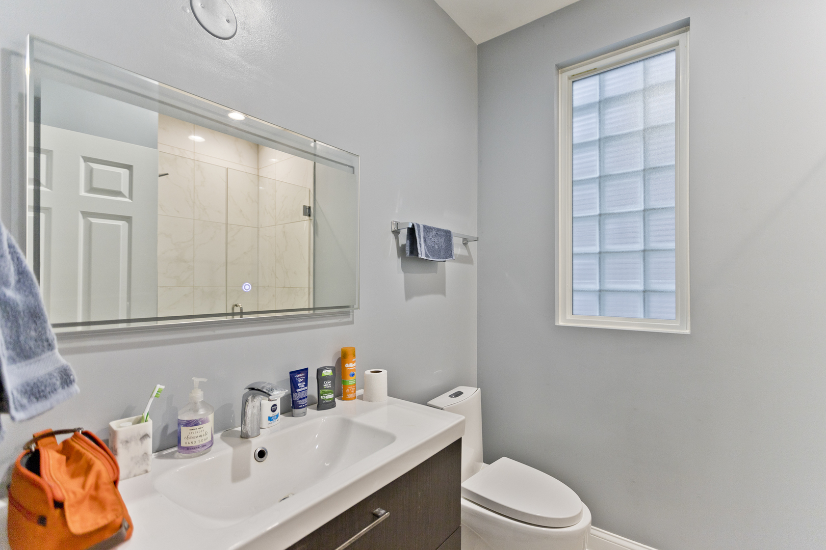 Undisclosed Address Chicago, IL 60614 - Photo 10 of 21 a bathroom with a sink vanity mirror and toilet