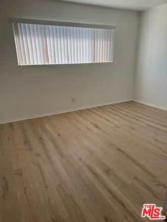 an empty room with wooden floor