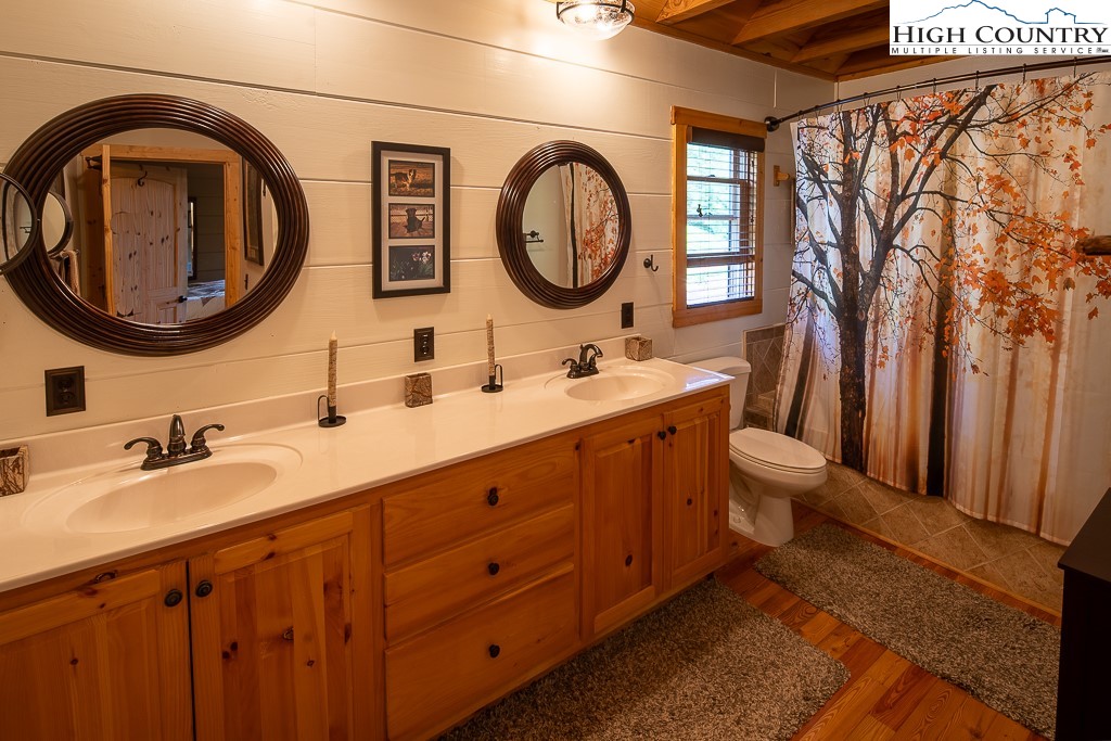 2191 Sorrento Drive Boone, NC 28607 - Photo 16 of 48 a bathroom with a double vanity sink and a mirror