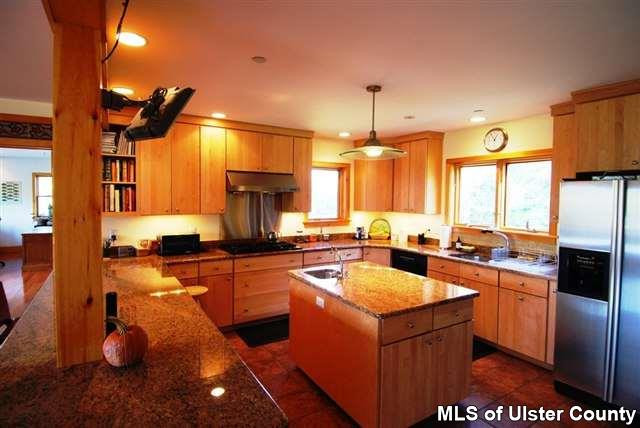 44 Pine Cove Road Stone Ridge, NY 12484 - Photo 3 of 7 a kitchen with stainless steel appliances granite countertop a sink a stove and a refrigerator