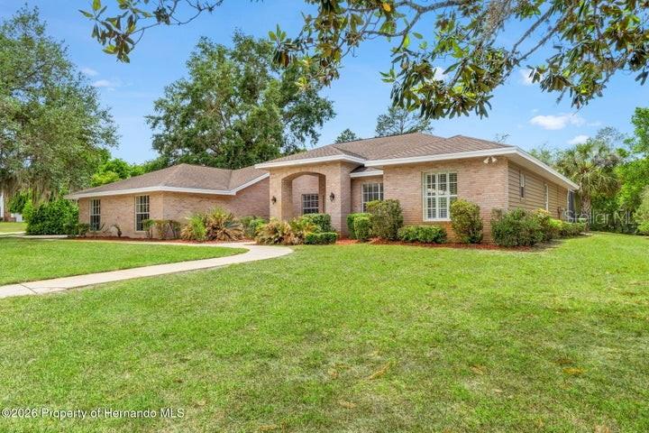 6153 New Osprey Point Weeki Wachee, FL 34607 - Photo 11 of 65 a front view of house with yard and green space