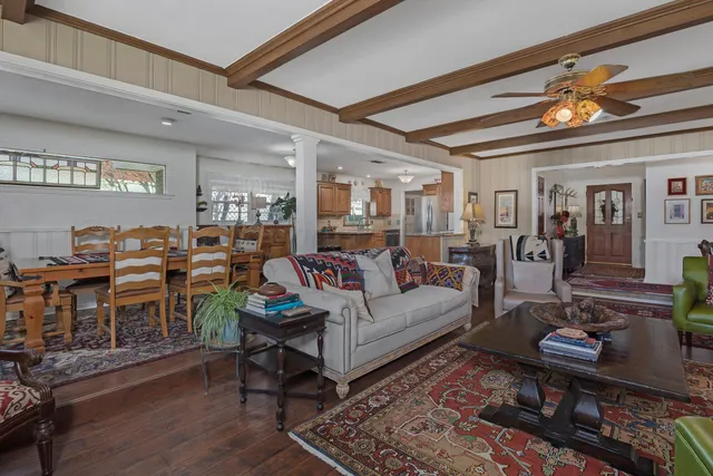 a living room with furniture a rug and a chandelier