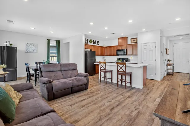 a living room with furniture and kitchen view
