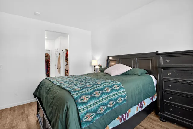 a bedroom with a bed and a dresser