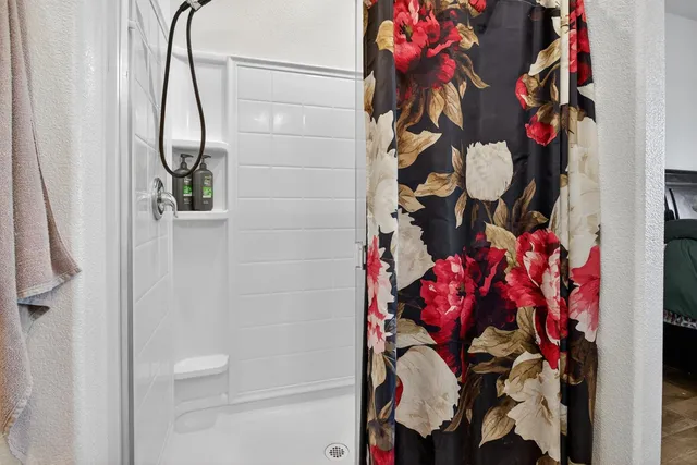 a bathroom with a bathtub and a shower curtain