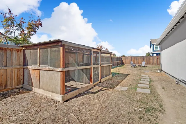 a backyard of a house with table and chairs