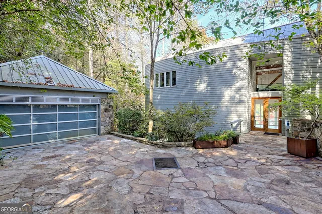 a living room with furniture fireplace and a large window