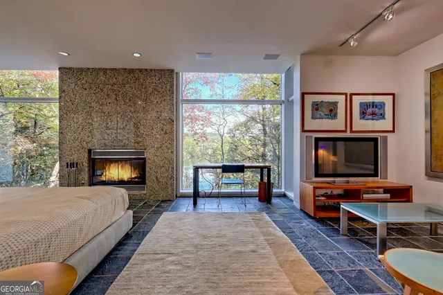 a view of a living room with furniture and a floor to ceiling window
