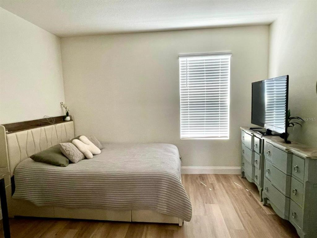 2771 Common Fig Run Wesley Chapel, FL 33543 - Photo 12 of 16 a bedroom with a bed and window