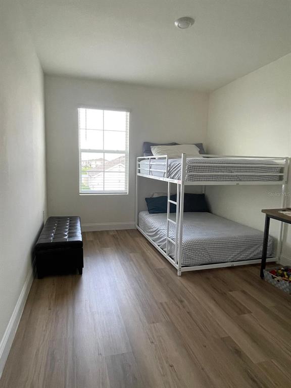 2771 Common Fig Run Wesley Chapel, FL 33543 - Photo 13 of 16 a bedroom with a bed and a window