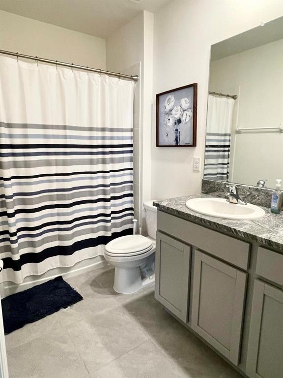 2771 Common Fig Run Wesley Chapel, FL 33543 - Photo 14 of 16 a bathroom with a toilet a sink and a mirror