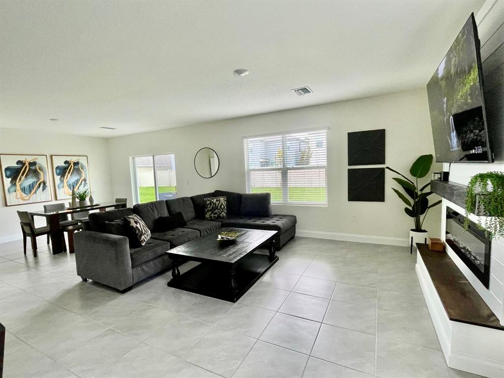 2771 Common Fig Run Wesley Chapel, FL 33543 - Photo 4 of 16 a living room with furniture and a flat screen tv