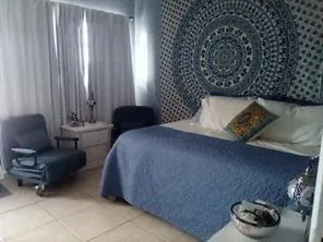 a bedroom with a bed and a chair