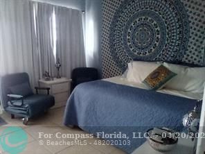 725 Southwest 11th Avenue, Unit 6F Hallandale Beach, FL 33009 - Photo 1 of 12 a bedroom with a bed and a couch