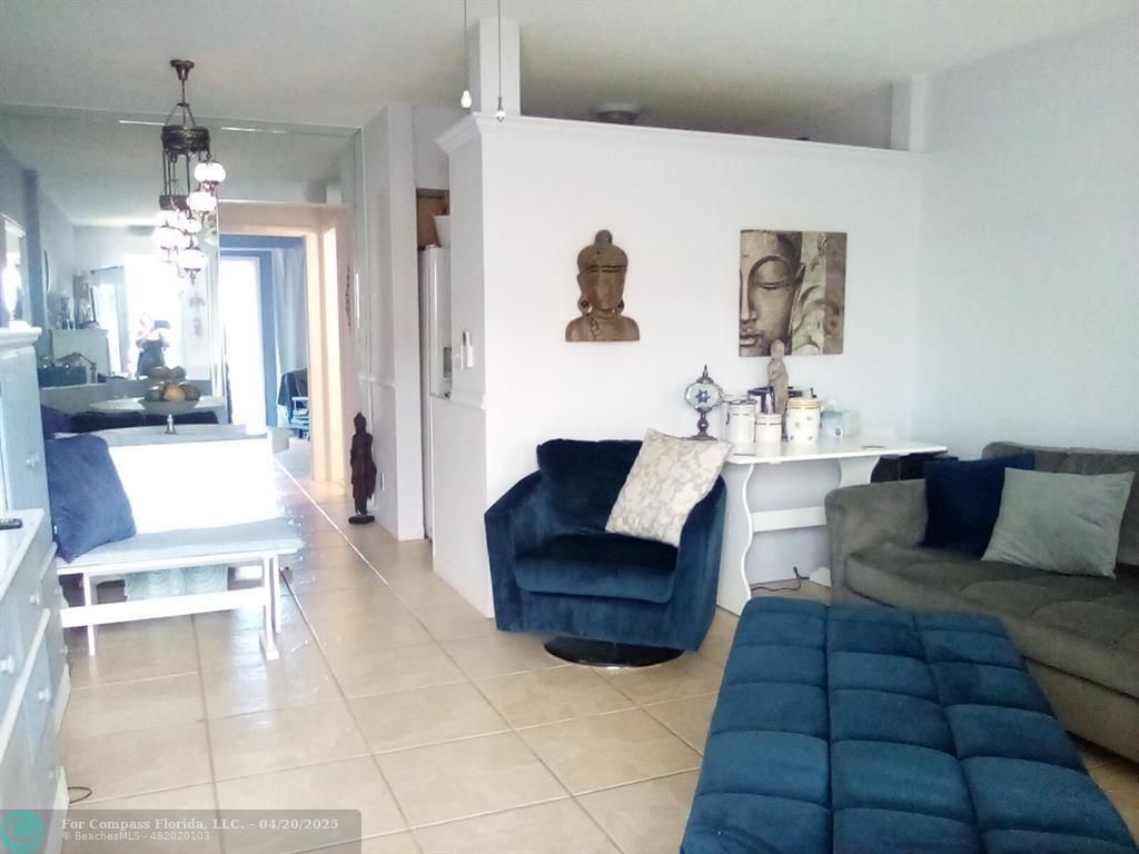 725 Southwest 11th Avenue, Unit 6F Hallandale Beach, FL 33009 - Photo 4 of 12 a living room with furniture and a chandelier