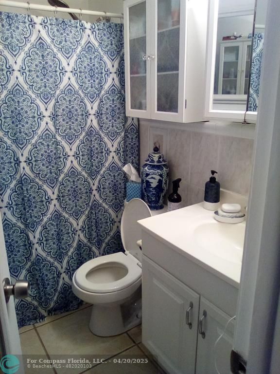 725 Southwest 11th Avenue, Unit 6F Hallandale Beach, FL 33009 - Photo 5 of 12 a bathroom with a toilet a sink and a shower