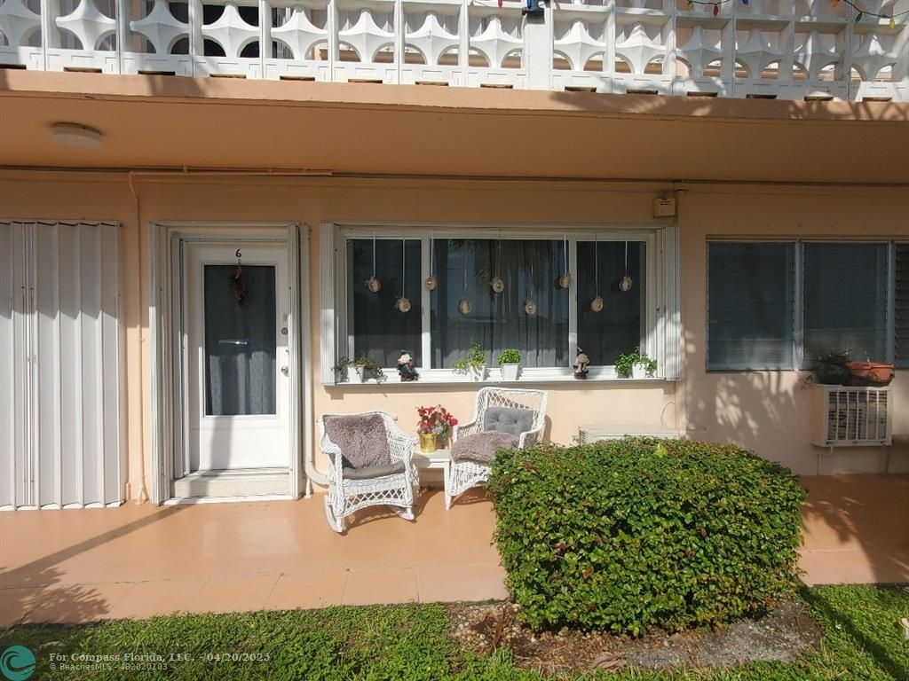 725 Southwest 11th Avenue, Unit 6F Hallandale Beach, FL 33009 - Photo 7 of 12 front view of a building with a garden and patio