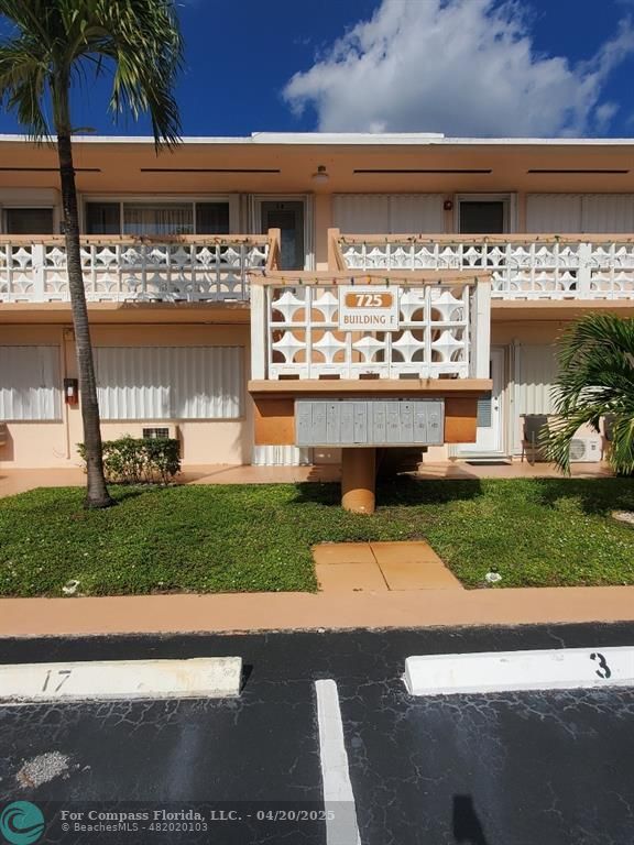 725 Southwest 11th Avenue, Unit 6F Hallandale Beach, FL 33009 - Photo 8 of 12 a front view of a house with a garden and pathway